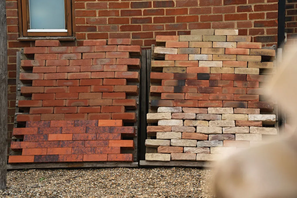 Sample brick panels lined up against a wall for colour matching